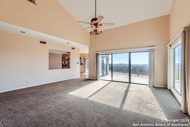 unfurnished living room featuring carpet, ceiling fan, and high vaulted ceiling