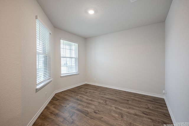 empty room with dark hardwood / wood-style floors