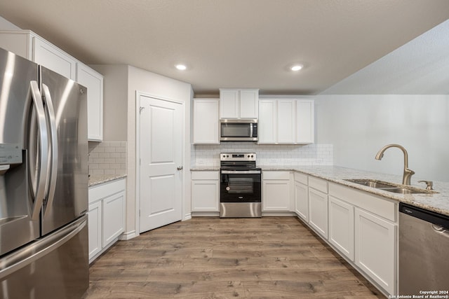 kitchen featuring white cabinets, sink, and stainless steel appliances