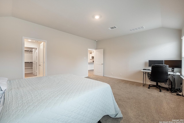 carpeted bedroom with a spacious closet, a closet, and lofted ceiling