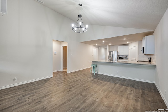 kitchen with white cabinetry, stainless steel appliances, tasteful backsplash, dark hardwood / wood-style flooring, and high vaulted ceiling