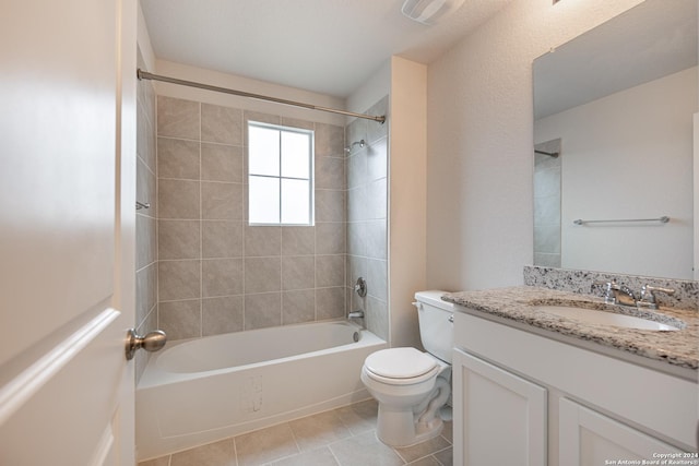 full bathroom featuring tile patterned flooring, vanity, toilet, and tiled shower / bath