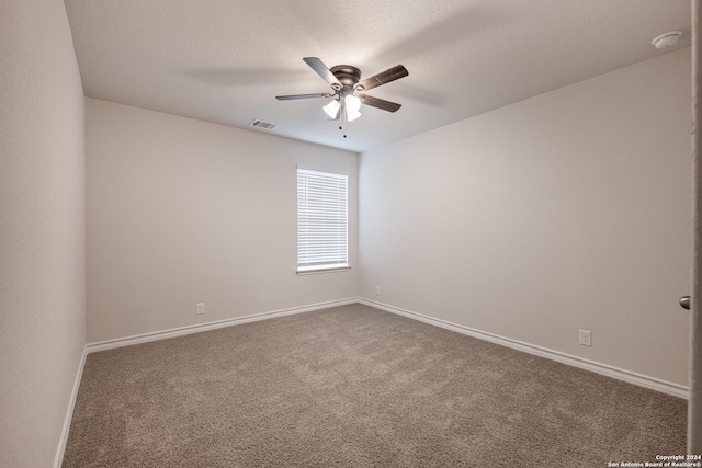 carpeted empty room with a textured ceiling and ceiling fan