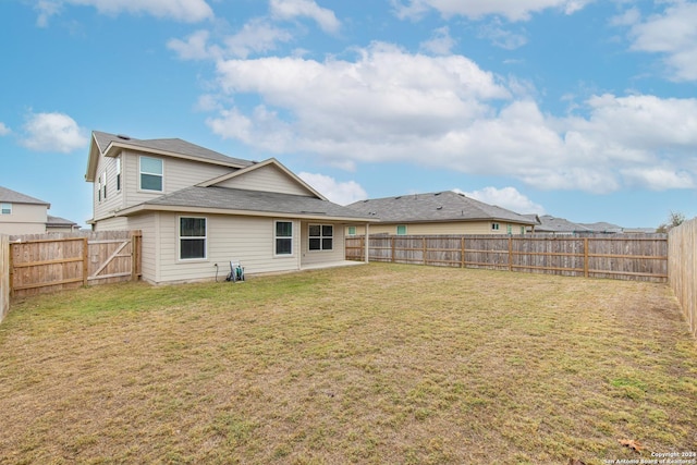 back of property featuring a yard