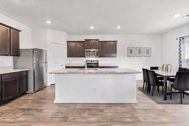 3146 Jackson Smt, Converse, TX 78109 - kitchen featuring appliances with stainless steel finishes, dark brown cabinetry, light wood-style floors, and recessed lighting