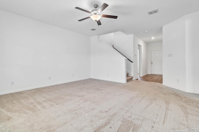 unfurnished living room with ceiling fan and light carpet