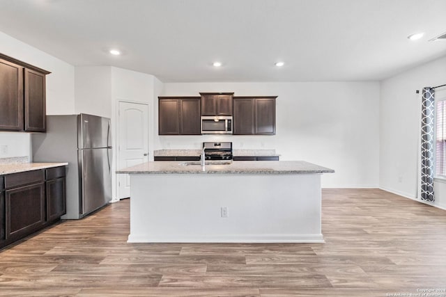 3146 Jackson Smt, Converse, TX 78109 - kitchen with stainless steel appliances, dark brown cabinetry, light wood-type flooring, and recessed lighting