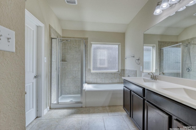 bathroom with tile patterned floors, vanity, independent shower and bath, and vaulted ceiling