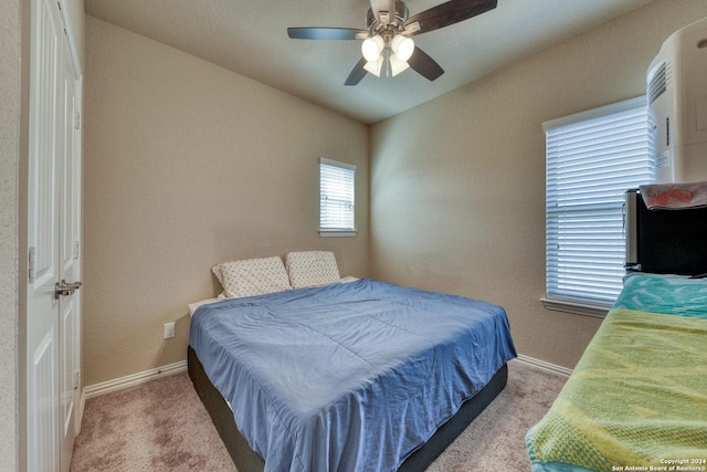 carpeted bedroom with ceiling fan and vaulted ceiling