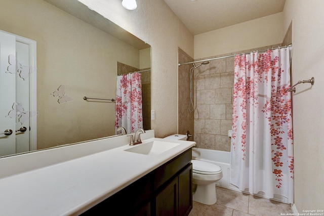 full bathroom featuring a textured ceiling, vanity, shower / tub combo with curtain, tile patterned flooring, and toilet