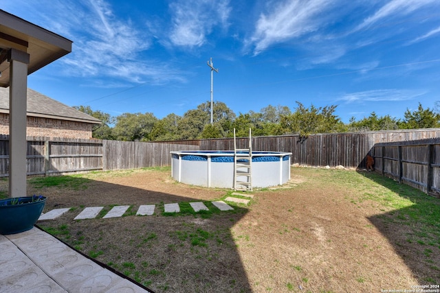 view of yard with a fenced in pool