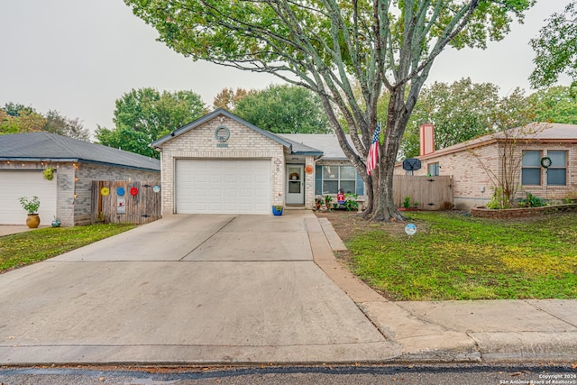 ranch-style house featuring a garage and a front yard