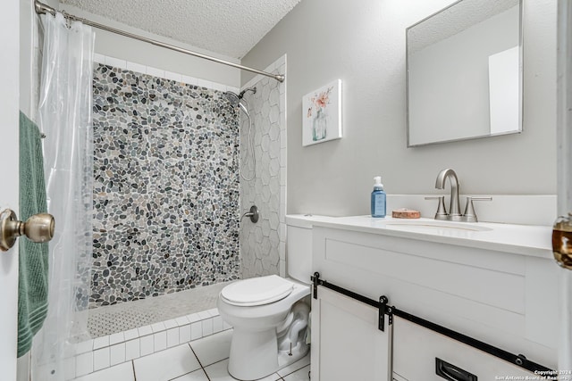 bathroom with vanity, tile patterned floors, toilet, a textured ceiling, and curtained shower