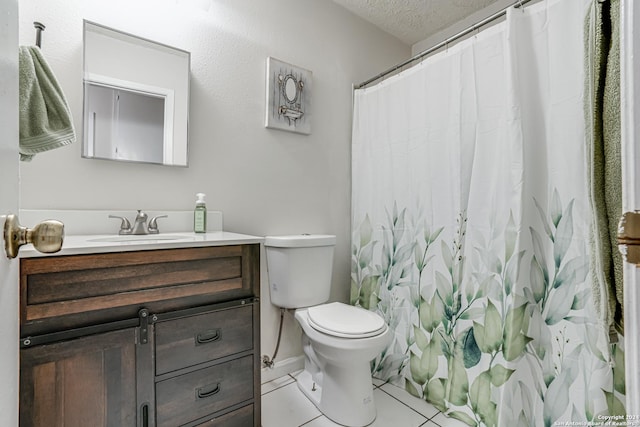 bathroom featuring tile patterned flooring, vanity, a textured ceiling, and toilet