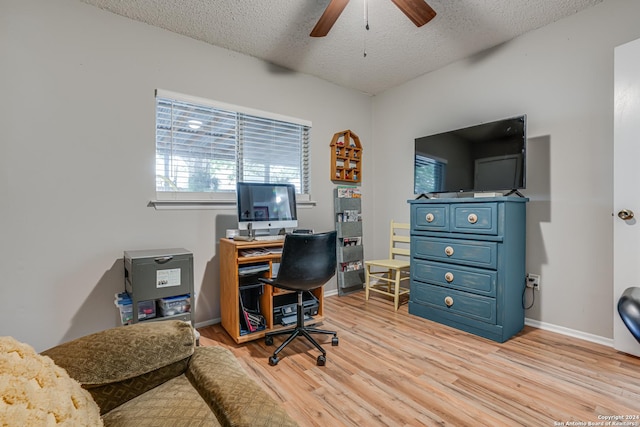 office with ceiling fan, light hardwood / wood-style floors, and a textured ceiling