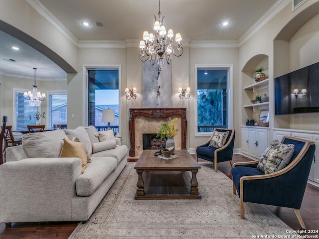 living room featuring crown molding, built in features, and hardwood / wood-style flooring