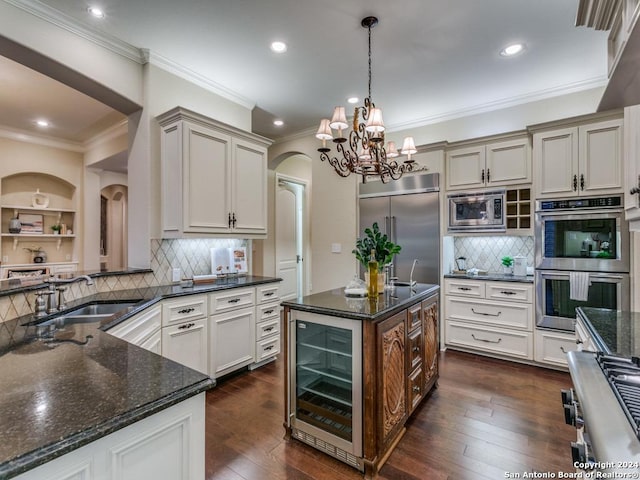 kitchen featuring built in appliances, dark hardwood / wood-style floors, sink, and beverage cooler