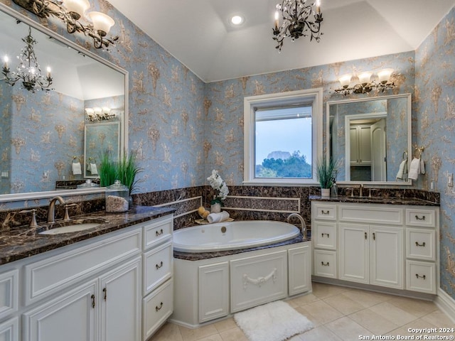 bathroom featuring tile patterned flooring, a bath, vanity, and vaulted ceiling