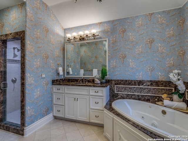 bathroom with tile patterned flooring, shower with separate bathtub, vanity, and vaulted ceiling