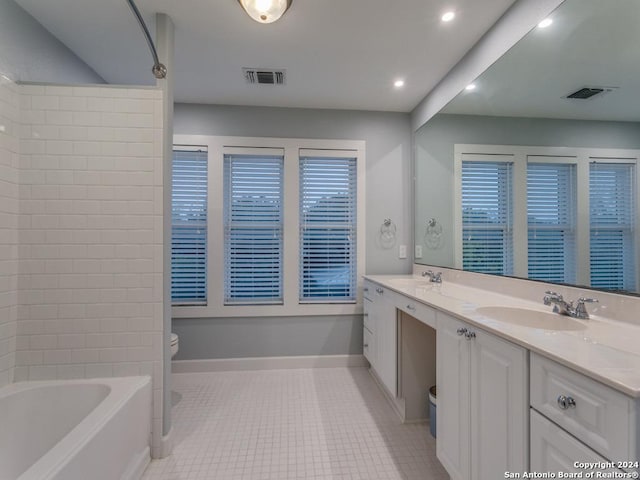 bathroom with tile patterned flooring, vanity, and toilet