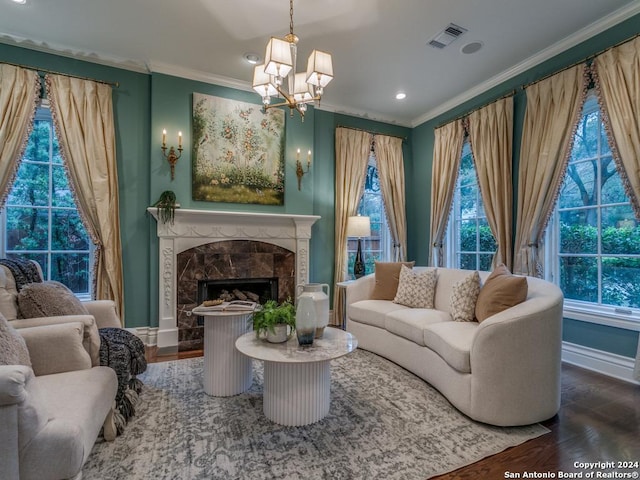 living room featuring wood-type flooring, crown molding, a high end fireplace, and a chandelier