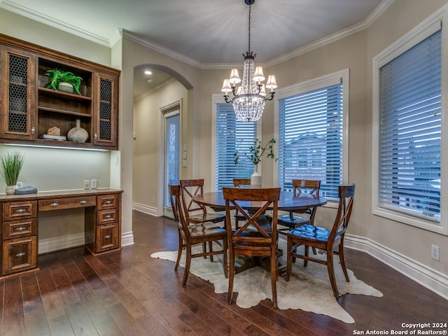 dining space with dark hardwood / wood-style flooring, a notable chandelier, and ornamental molding