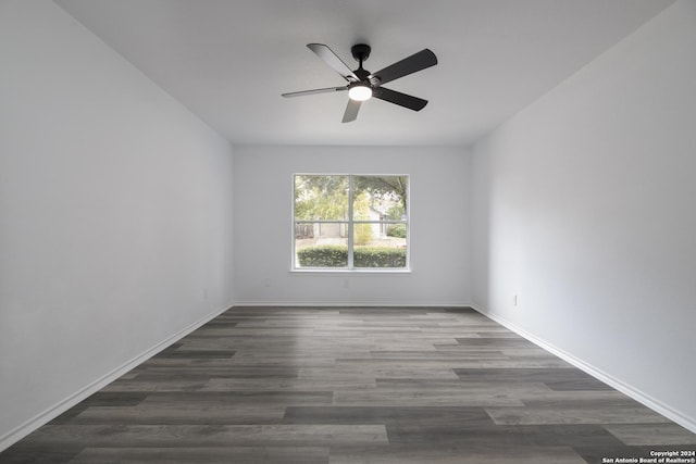 spare room featuring dark hardwood / wood-style flooring and ceiling fan