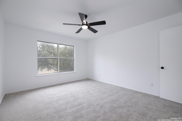 spare room featuring carpet flooring and ceiling fan