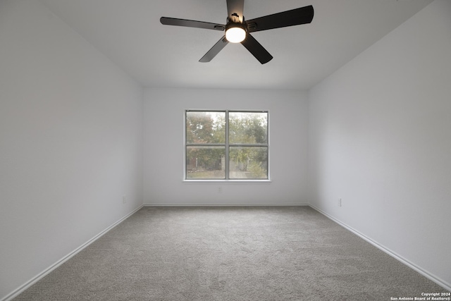 empty room with ceiling fan and carpet floors