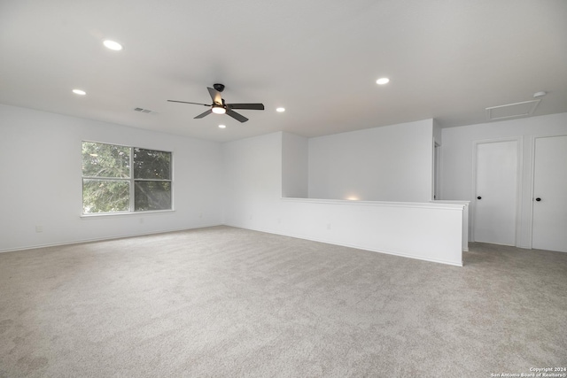 spare room with light carpet and ceiling fan