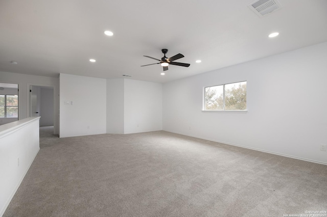 unfurnished room featuring ceiling fan and light colored carpet