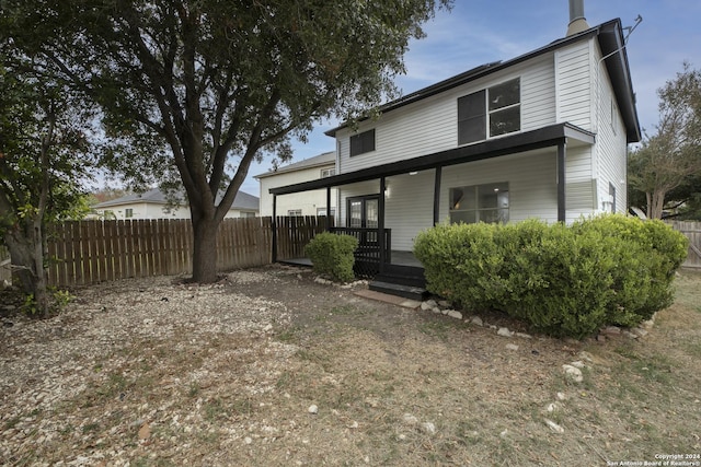 rear view of house featuring a porch