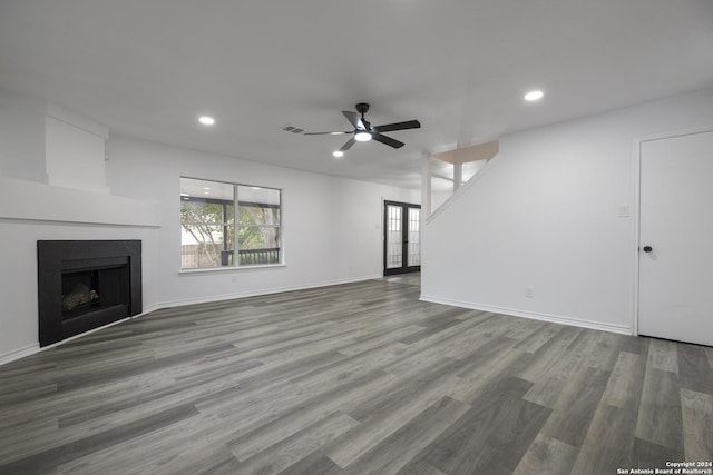 unfurnished living room with hardwood / wood-style floors and ceiling fan