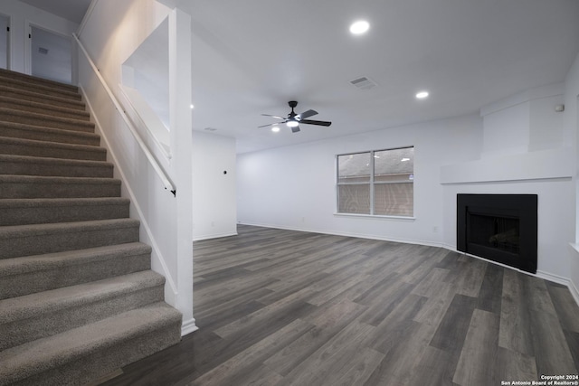 unfurnished living room featuring dark hardwood / wood-style floors and ceiling fan