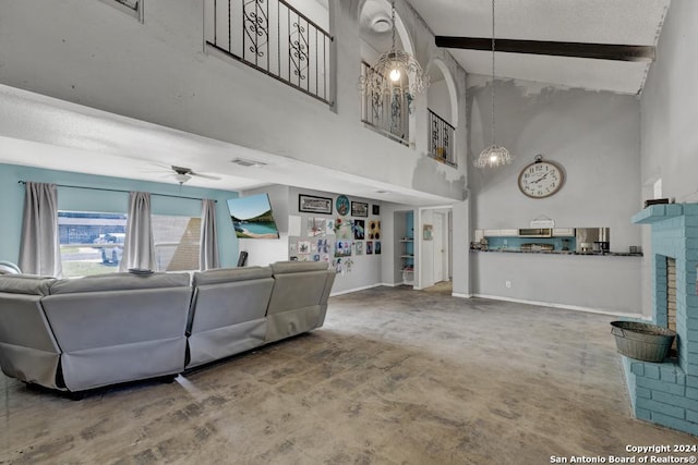 living room with carpet flooring, ceiling fan, high vaulted ceiling, beamed ceiling, and a fireplace