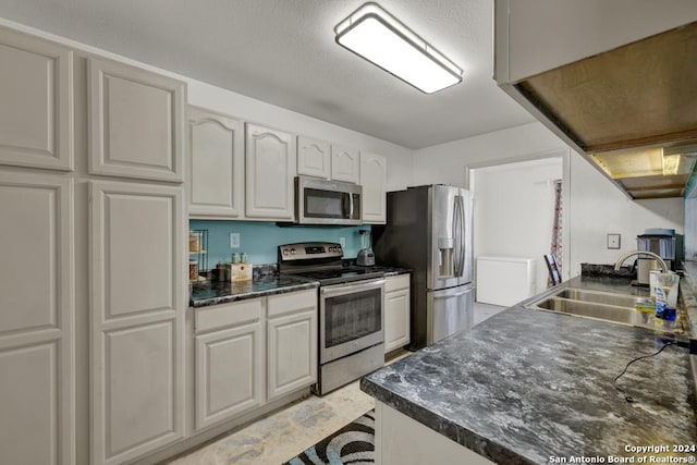 kitchen featuring sink, white cabinets, and appliances with stainless steel finishes