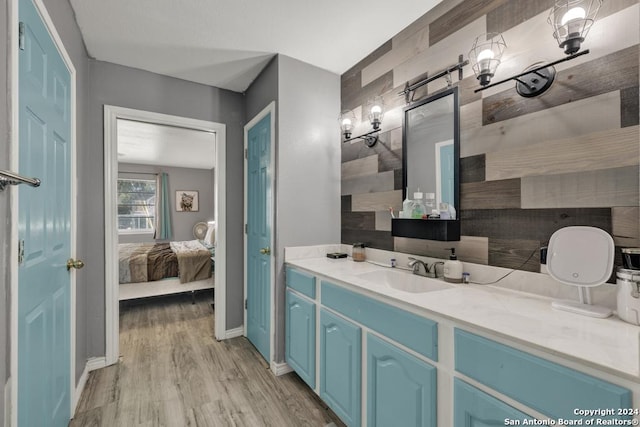 bathroom with decorative backsplash, vanity, and hardwood / wood-style flooring