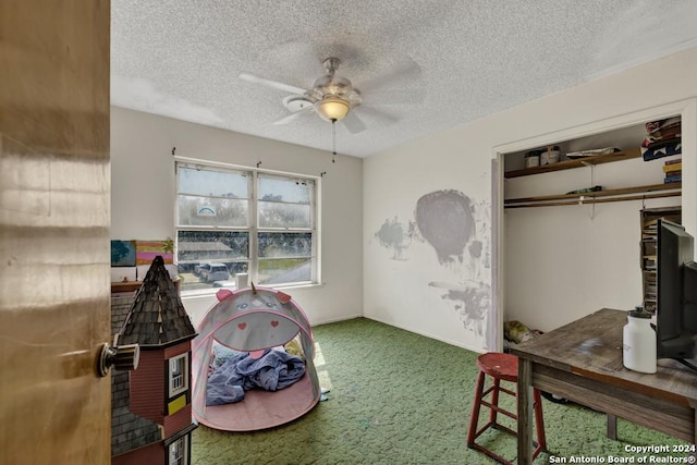 carpeted bedroom featuring a textured ceiling, a closet, and ceiling fan