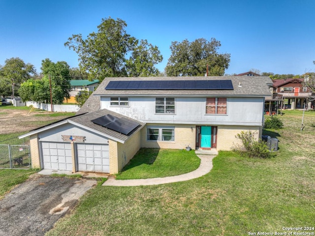 front facade with solar panels, a garage, and a front lawn