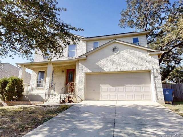 front facade with a porch and a garage