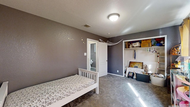 bedroom featuring dark colored carpet and a closet