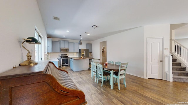 dining space featuring light hardwood / wood-style floors and sink