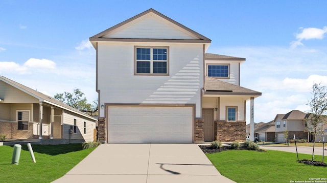 view of front of home with a garage and a front lawn