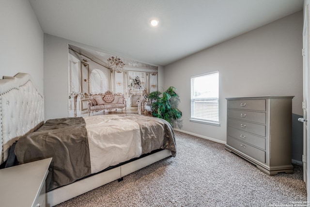 bedroom with carpet floors and lofted ceiling