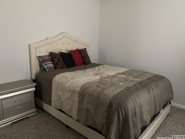 bedroom featuring dark carpet