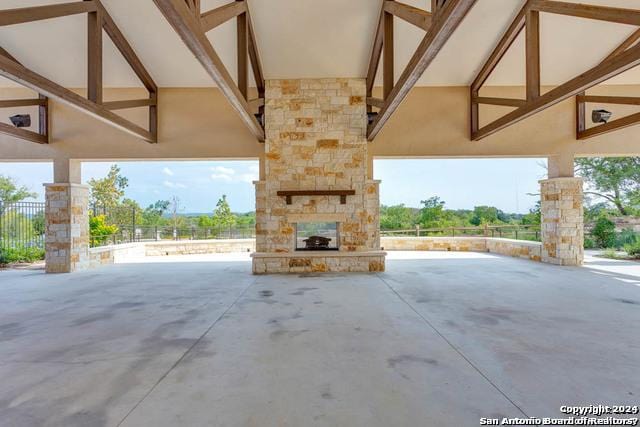 view of patio / terrace featuring an outdoor stone fireplace