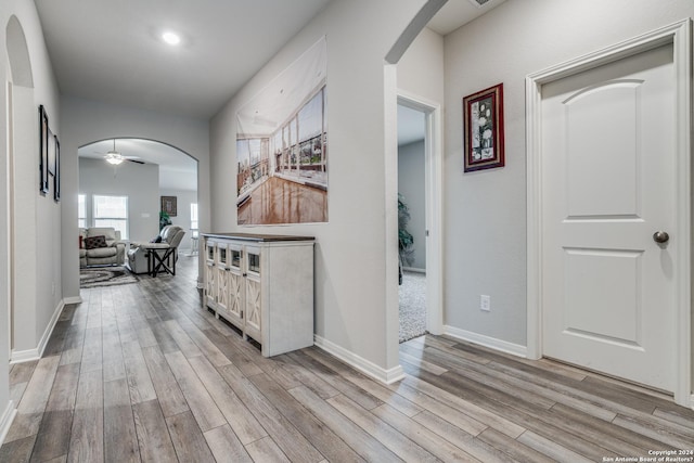 corridor with light hardwood / wood-style floors