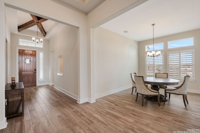 entryway featuring a notable chandelier, beam ceiling, and wood-type flooring