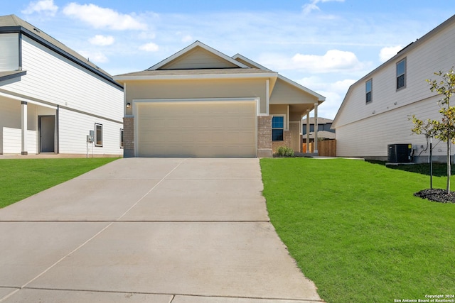 view of front of house featuring a garage, central air condition unit, and a front yard