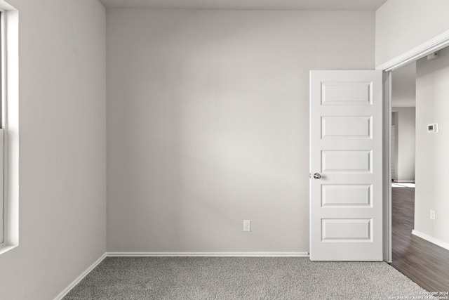 empty room with hardwood / wood-style flooring